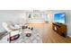 Open-concept living room features hardwood floors, comfortable seating, and an adjacent kitchen at 3062 Eastland Blvd # 405, Clearwater, FL 33761