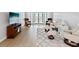 Bright living room with hardwood floors, comfortable seating, and a walk-out balcony at 3062 Eastland Blvd # 405, Clearwater, FL 33761