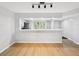 Open concept living room, kitchen, and dining space with hardwood floors at 3062 Eastland Blvd # 405, Clearwater, FL 33761