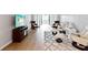 Bright living room with hardwood floors, comfortable seating, and a walk-out balcony at 3062 Eastland Blvd # 405, Clearwater, FL 33761