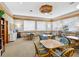 A meeting room with multiple tables, chairs, large windows, and ample natural light at 3062 Eastland Blvd # 405, Clearwater, FL 33761