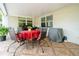 Covered back porch has tile flooring and outdoor furniture with a view of the backyard at 3217 Saddlebrook Ave, Tampa, FL 33618
