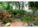 Beautiful backyard has mature landscaping and an arbor with seating beneath at 3217 Saddlebrook Ave, Tampa, FL 33618