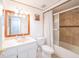 Bright bathroom features a shower-tub combination and a large wood-framed mirror at 3217 Saddlebrook Ave, Tampa, FL 33618