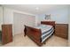 Comfortable bedroom with a classic wood frame bed and ample closet space at 3217 Saddlebrook Ave, Tampa, FL 33618