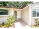 Close up of home's entryway with patterned tile and lush plantings at 3217 Saddlebrook Ave, Tampa, FL 33618