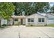 Home with a well-maintained exterior, sidewalk, and decorative plantings at 3217 Saddlebrook Ave, Tampa, FL 33618
