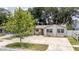 Charming single-story home with a well-maintained front yard and a mature shade tree at 3217 Saddlebrook Ave, Tampa, FL 33618