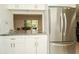 Open kitchen with stainless steel refrigerator, granite countertops and a view into the dining area at 3217 Saddlebrook Ave, Tampa, FL 33618