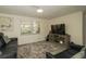 Cozy living room featuring plush seating, a large TV, and ample natural light at 3217 Saddlebrook Ave, Tampa, FL 33618