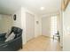 Open living room with tile flooring and access to the front door at 3217 Saddlebrook Ave, Tampa, FL 33618