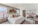 Bedroom with neutral colors, multiple windows, woven decorations and bench with nature-themed art at 36164 Sunflower Hill Dr, Zephyrhills, FL 33541