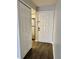 Hallway view of a front door and closet, with a stainless steel refrigerator visible in the kitchen at 3802 N Oak Dr # W22, Tampa, FL 33611