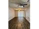 Bright living room with modern wood floors, ceiling fan, and natural light at 3802 N Oak Dr # W22, Tampa, FL 33611