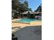 Community pool with chairs and table at 3802 N Oak Dr # W22, Tampa, FL 33611