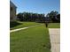 Spacious grass yard with sidewalk and view of a small bridge over the water at 3802 N Oak Dr # W22, Tampa, FL 33611