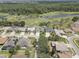 Aerial view of the neighborhood and golf course with mature trees and lush landscaping at 3813 Salida Delsol Dr, Ruskin, FL 33573