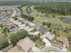 Aerial view of the neighborhood and golf course with mature trees and lush landscaping at 3813 Salida Delsol Dr, Ruskin, FL 33573