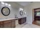 Bathroom with double sink vanity, a tiled floor, and a glass enclosed shower at 3813 Salida Delsol Dr, Sun City Center, FL 33573