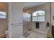 Bright bathroom featuring a glass enclosed shower, tiled floors, and a window at 3813 Salida Delsol Dr, Ruskin, FL 33573