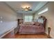 Large primary bedroom suite with hardwood floors, window, and ceiling fan at 3813 Salida Delsol Dr, Sun City Center, FL 33573