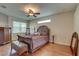 Well-lit primary bedroom suite with hardwood floors, large window, and ceiling fan at 3813 Salida Delsol Dr, Ruskin, FL 33573