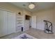 Bright room featuring a closet, wall shelving, television and tile floors at 3813 Salida Delsol Dr, Ruskin, FL 33573