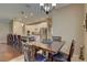 Dining room with modern chandelier that connects to the kitchen, featuring a table with seating for four at 3813 Salida Delsol Dr, Ruskin, FL 33573