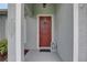 Inviting front entrance featuring a charming red door at 3813 Salida Delsol Dr, Ruskin, FL 33573