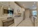 Well-lit kitchen featuring stainless steel appliances, tile flooring, and granite countertops at 3813 Salida Delsol Dr, Ruskin, FL 33573
