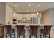 Kitchen bar with granite countertops, pendant lighting, stainless appliances, and seating for four at 3813 Salida Delsol Dr, Ruskin, FL 33573