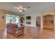 Spacious living room boasts hardwood floors, stone accent wall, fireplace, and access to the screened-in lanai at 3813 Salida Delsol Dr, Sun City Center, FL 33573