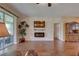Bright living room with hardwood floors, stone accent wall, fireplace, and sliding glass doors to the outdoor area at 3813 Salida Delsol Dr, Ruskin, FL 33573