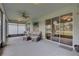 Covered patio with comfortable seating, fan, and view of the lush green landscape at 3813 Salida Delsol Dr, Sun City Center, FL 33573