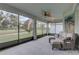 Screened lanai featuring a ceiling fan, furniture, and serene golf course views at 3813 Salida Delsol Dr, Ruskin, FL 33573