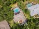 Aerial view of a private home with a screened-in pool and lush landscaping at 3821 Turkey Oak Dr, Valrico, FL 33596
