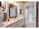 Bright bathroom with a vanity and decorative mirror, connecting to other rooms at 3821 Turkey Oak Dr, Valrico, FL 33596