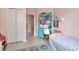 Cozy bedroom featuring a colorful desk, comfortable bed, and a view to the hallway at 3821 Turkey Oak Dr, Valrico, FL 33596