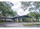 This is a beautiful clubhouse with lush landscaping and stately stone columns, inviting visitors into its welcoming entrance at 3821 Turkey Oak Dr, Valrico, FL 33596