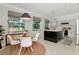 Dining area with table set and view of modern kitchen featuring stainless appliances and white countertops at 3821 Turkey Oak Dr, Valrico, FL 33596