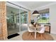 Dining area with modern table set with seating and sliding doors to covered outdoor living space at 3821 Turkey Oak Dr, Valrico, FL 33596