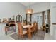Elegant dining room with a stylish light fixture, large windows, and modern furnishings at 3821 Turkey Oak Dr, Valrico, FL 33596