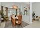 Bright dining room featuring a wooden table, modern decor, and expansive windows with plantation shutters at 3821 Turkey Oak Dr, Valrico, FL 33596