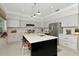 Bright kitchen features gray cabinets, stainless appliances, black island with white countertop, and recessed lighting at 3821 Turkey Oak Dr, Valrico, FL 33596
