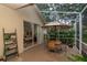 Covered outdoor patio features seating area and view of landscaped backyard, and a peek into the bedroom at 3821 Turkey Oak Dr, Valrico, FL 33596