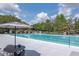 Enjoy the sunshine in this pristine community pool, complete with lap lanes, lounge chairs, and shaded seating area at 3821 Turkey Oak Dr, Valrico, FL 33596