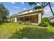 Expansive backyard view featuring a screened patio and lush landscaping, perfect for outdoor living at 4089 Windcrest Dr, Wesley Chapel, FL 33544