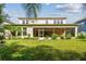 A well-maintained lawn and screened lanai enhance the backyard of this two-story home at 4089 Windcrest Dr, Wesley Chapel, FL 33544