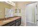Bathroom featuring granite countertops, dark wood cabinets, and a spacious layout at 4089 Windcrest Dr, Wesley Chapel, FL 33544