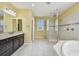 Bright bathroom featuring walk-in shower, tub, and double vanity at 4089 Windcrest Dr, Wesley Chapel, FL 33544